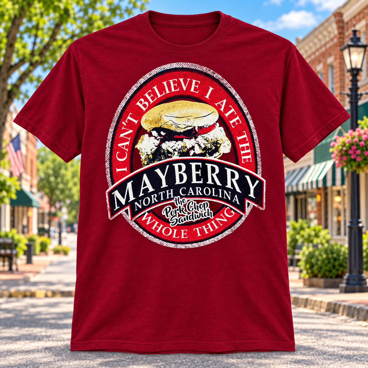 Mayberry Pork Chop Sandwich T-Shirt in Red against a bright Mayberry Main Street background