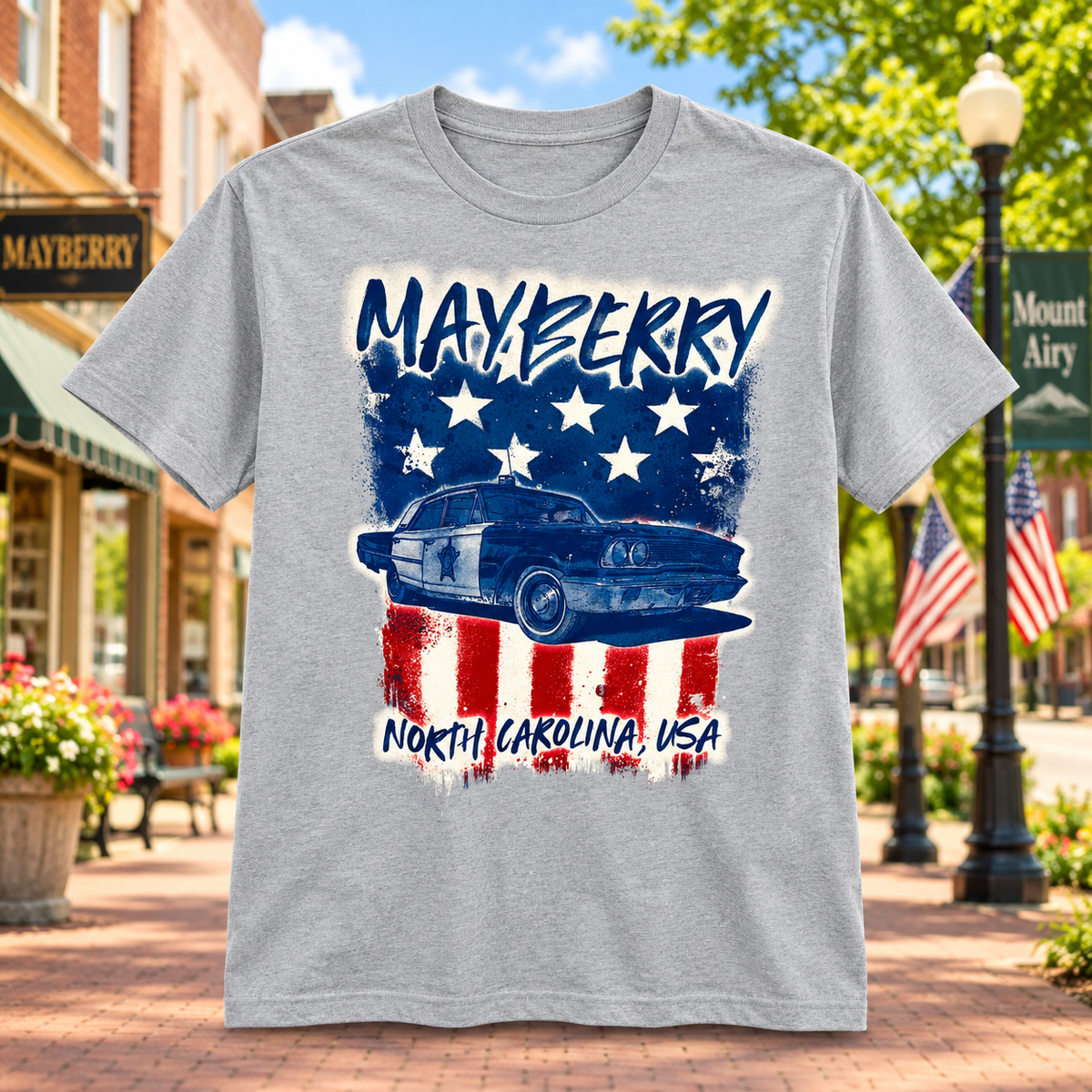 Mayberry North Carolina Squad Car Flag T-Shirt in Heather Gray against a bright Mayberry Main Street background