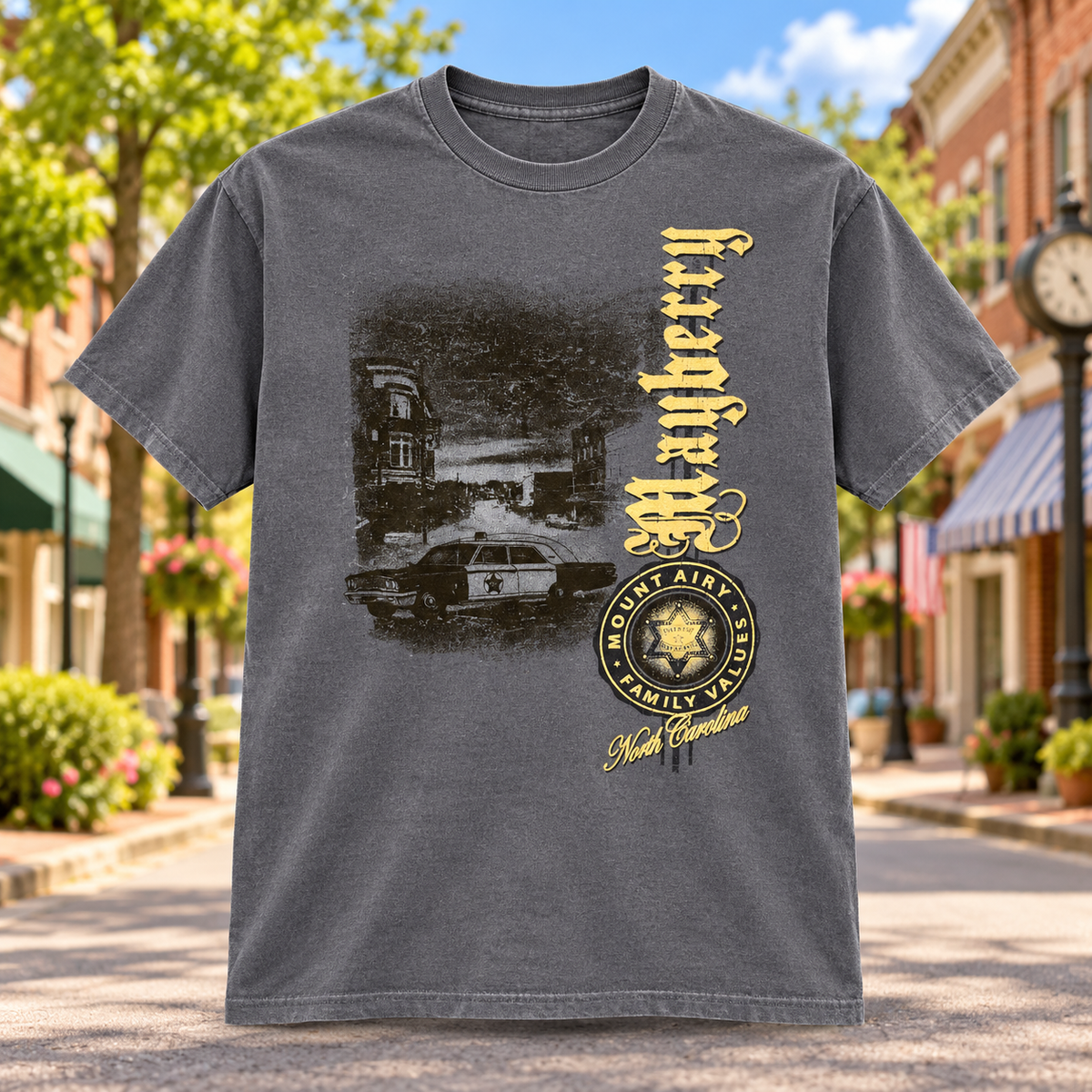 Mayberry Family Values Vertical Squad Car T-Shirt in Charcoal against a bright Mayberry Main Street background