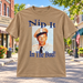 Nip It in the Bud T-Shirt in Tan against a bright Mayberry Main Street background