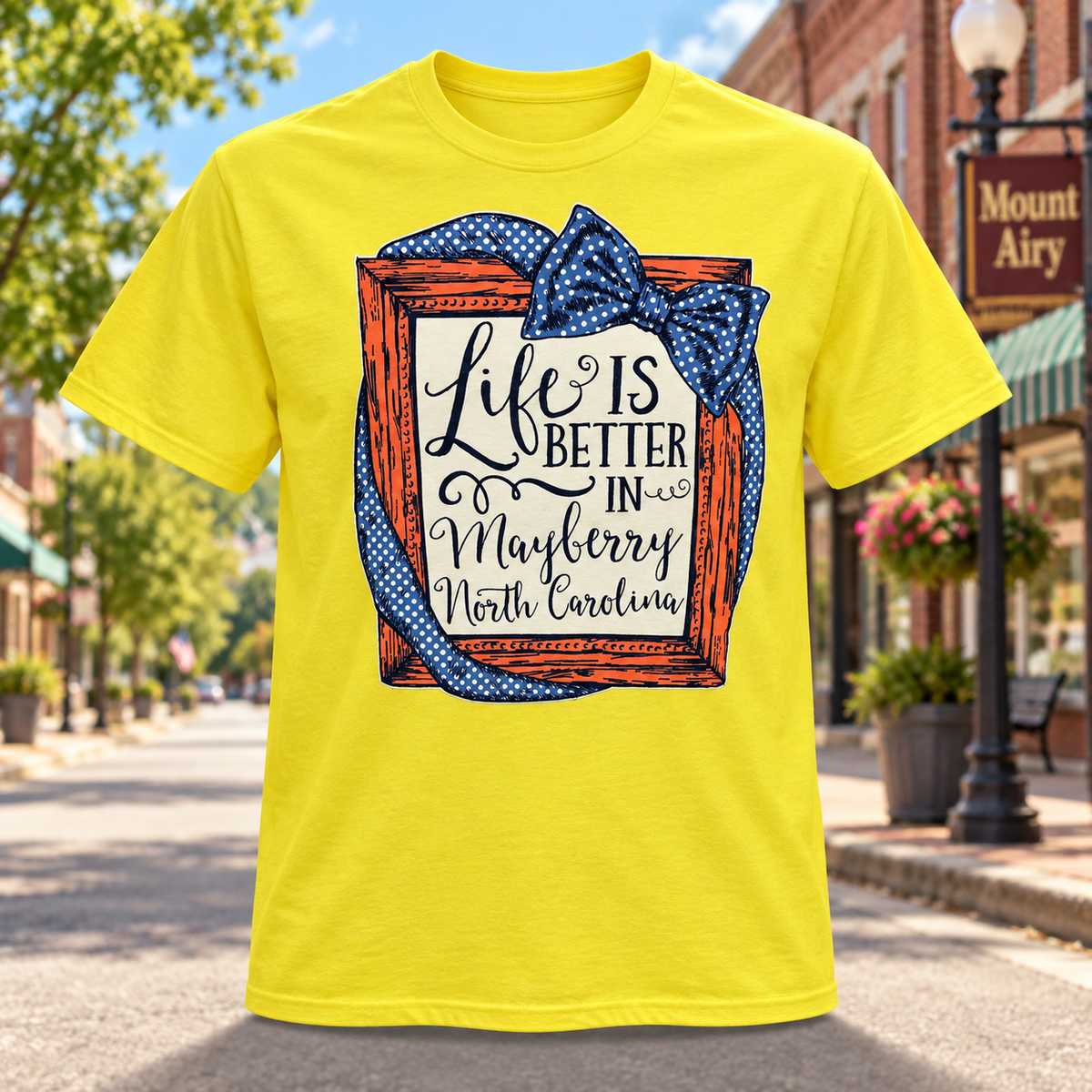 Life Is Better in Mayberry T-Shirt in Yellow against a bright Mayberry Main Street background