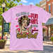 Mayberry Fun Girl Hello Doll T-Shirt in Light Pink against a bright Mayberry Main Street background