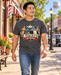 Man wearing Mayberry On Patrol T-Shirt – Charcoal walking on a Mayberry-inspired Main Street