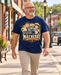 Man wearing Mayberry Miles Andy & Barney T-Shirt – Navy walking on a Mayberry-inspired Main Street
