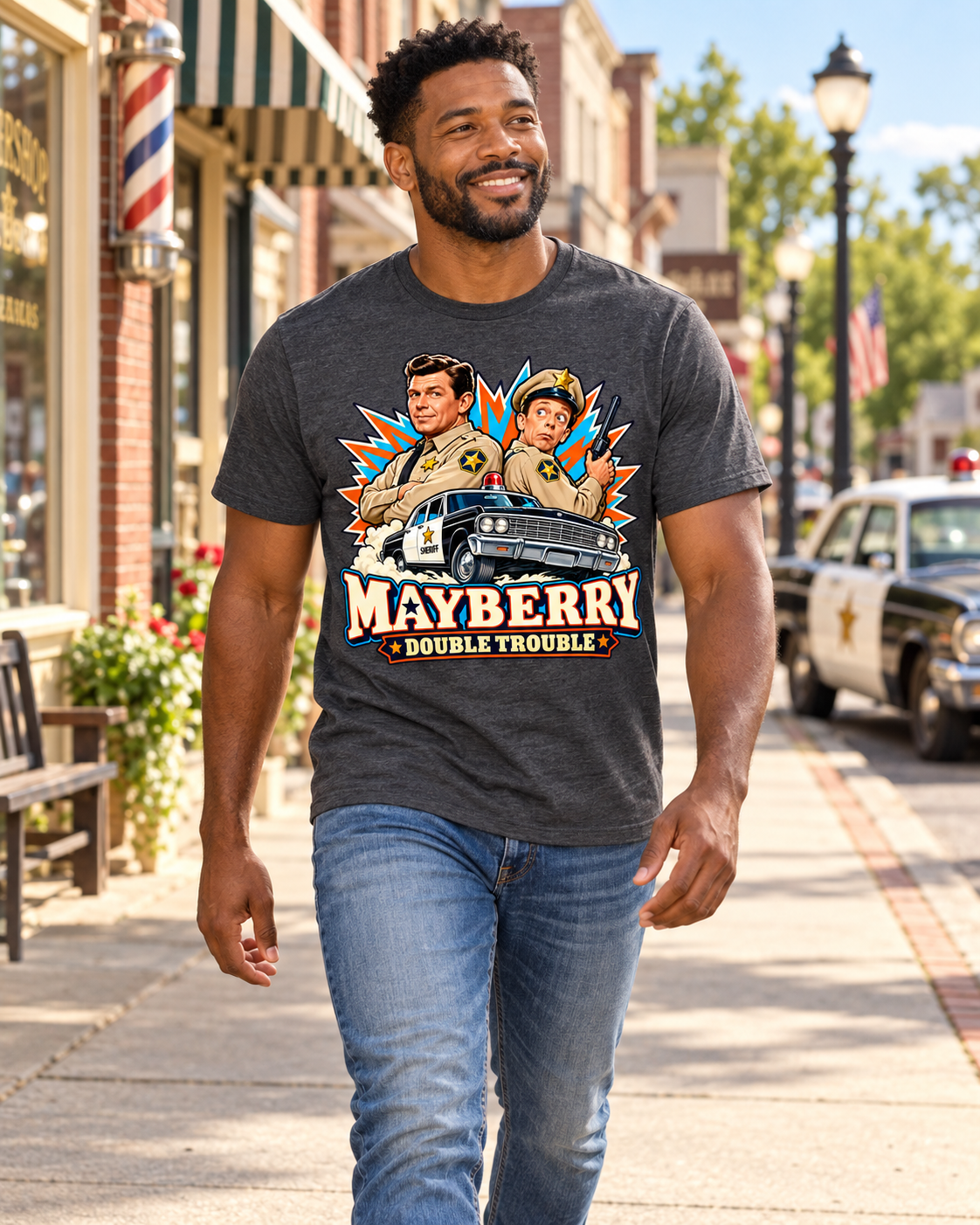 Man wearing Mayberry Double Trouble T-Shirt – Heather Charcoal walking on a Mayberry-inspired Main Street