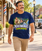 Man wearing Mayberry Fishin’ Mission T-Shirt – Navy walking on a Mayberry-inspired Main Street