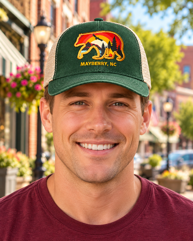 Model wearing Mayberry Mountain Bear Hat – Green on a Mayberry-style downtown street