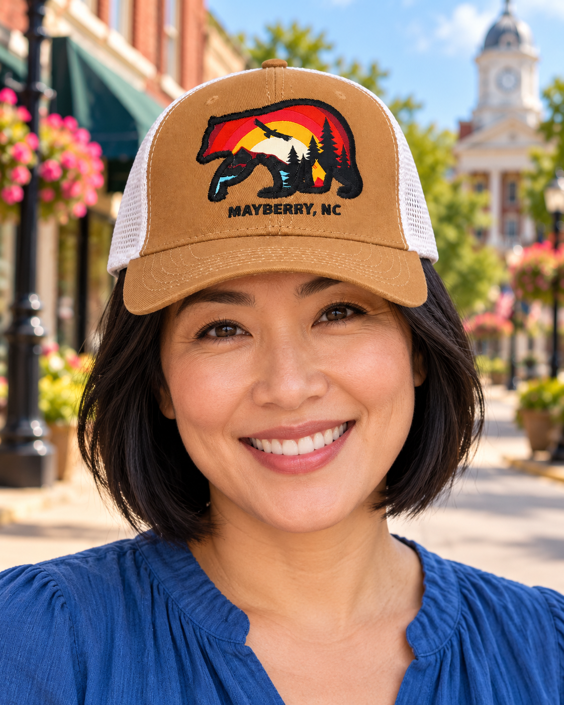 Model wearing Mayberry Mountain Bear Hat – Tan on a Mayberry-style downtown street