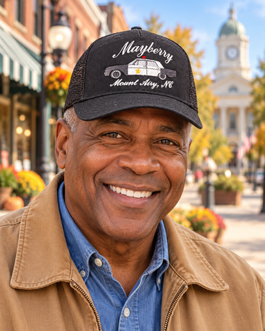 Model wearing Mayberry Squad Car Hat – Black on an autumn Mayberry-style downtown street