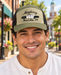 Model wearing Mayberry Squad Car Hat – Olive on a Mayberry-style downtown street