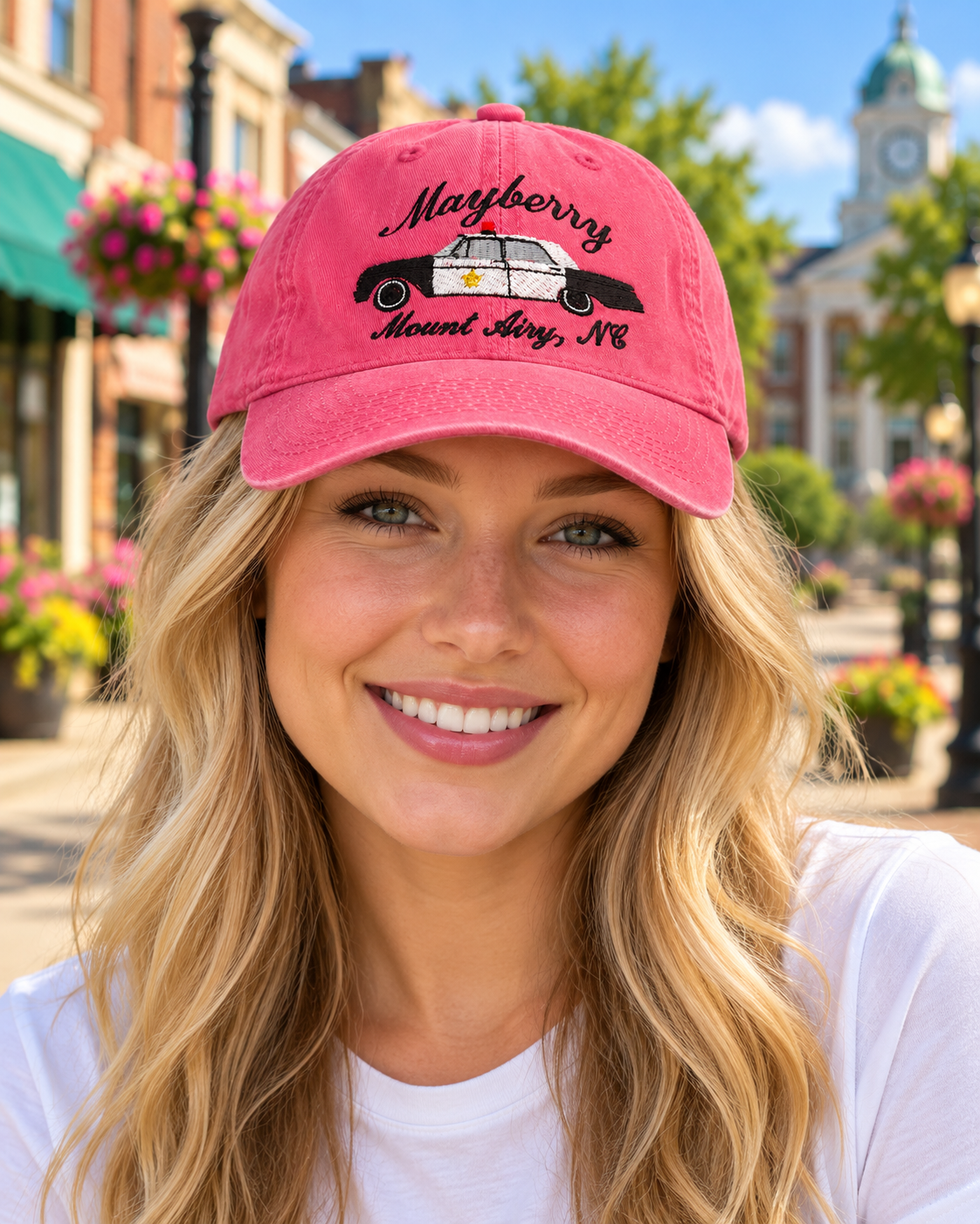 Model wearing Mayberry Squad Car Hat – Pink on a Mayberry-style downtown street