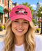 Model wearing Mayberry Squad Car Hat – Pink on a Mayberry-style downtown street
