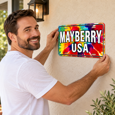 Man placing Mayberry Metal Sign - Mayberry USA on a wall