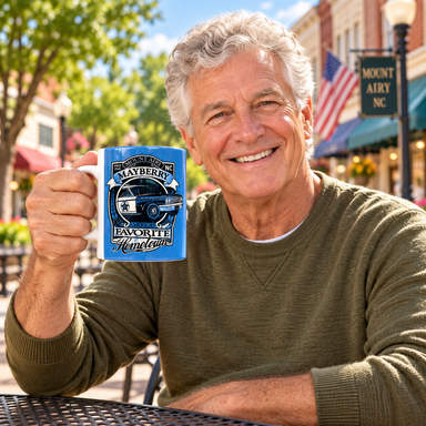 Model enjoying coffee with Mount Airy America's Favorite Hometown Blue Mug on Mayberry Main Street