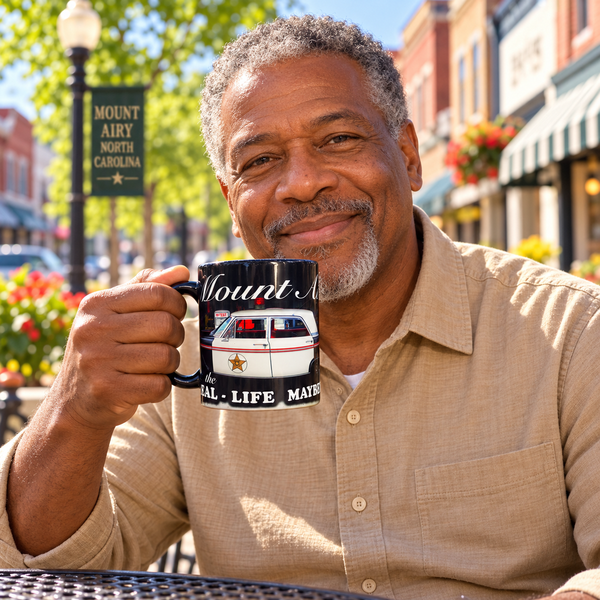 Model enjoying coffee with Mount Airy Real-Life Mayberry Squad Car Black Mug on Mayberry Main Street